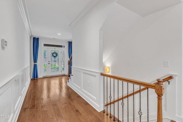 644 Angelica Cir, Cary, NC 27518 - hall with a decorative wall, crown molding, wainscoting, wood-type flooring, and stairs