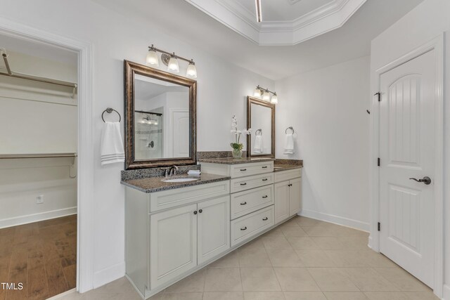 644 Angelica Cir, Cary, NC 27518 - full bathroom with a spacious closet, a shower, vanity, baseboards, and crown molding