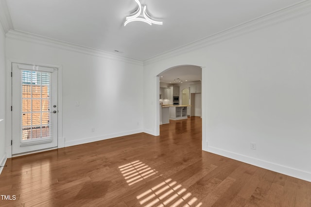 644 Angelica Cir, Cary, NC 27518 - empty room featuring ornamental molding, arched walkways, baseboards, and wood finished floors