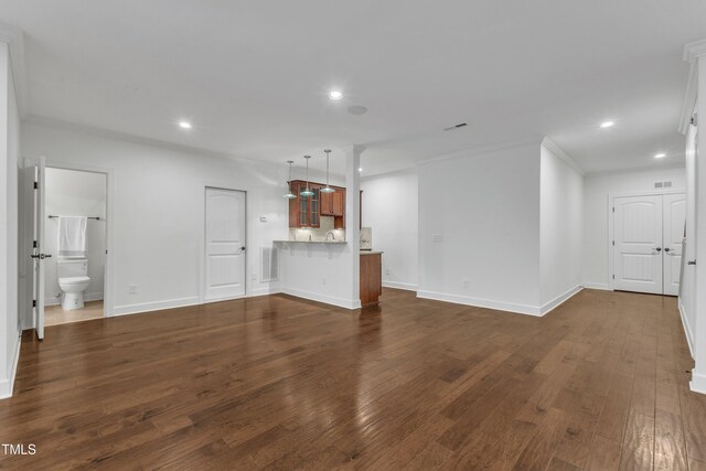 644 Angelica Cir, Cary, NC 27518 - unfurnished living room with recessed lighting, dark wood-style flooring, crown molding, and baseboards
