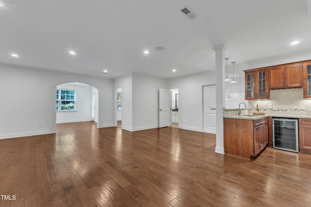 644 Angelica Cir, Cary, NC 27518 - kitchen featuring wine cooler, open floor plan, brown cabinets, recessed lighting, and tasteful backsplash