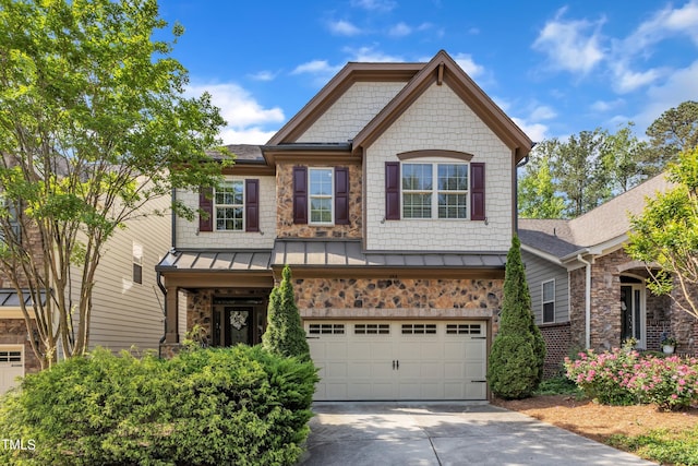 644 Angelica Cir, Cary, NC 27518 - view of front facade featuring an attached garage, concrete driveway, a standing seam roof, and stone siding