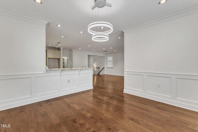 644 Angelica Cir, Cary, NC 27518 - unfurnished room featuring crown molding, wood finished floors, recessed lighting, and a decorative wall