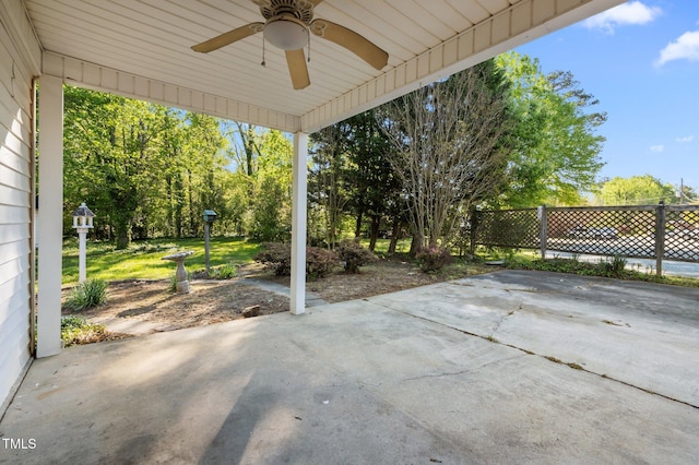 view of patio with fence and a ceiling fan