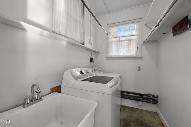 clothes washing area featuring cabinet space, independent washer and dryer, and a sink