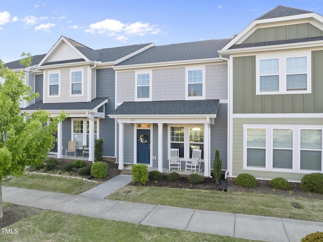 6511 Academic Ave, Raleigh, NC 27616 - townhome / multi-family property with a front lawn, roof with shingles, a porch, and board and batten siding