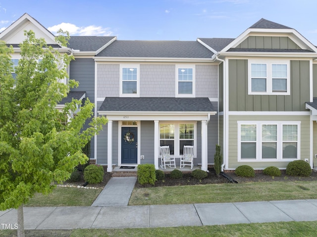 6511 Academic Ave, Raleigh, NC 27616 - multi unit property with roof with shingles, a front yard, board and batten siding, and covered porch