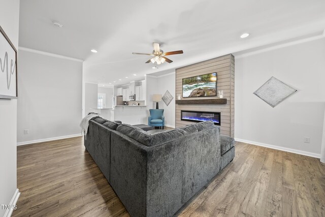 6511 Academic Ave, Raleigh, NC 27616 - living room featuring recessed lighting, wood finished floors, a ceiling fan, baseboards, and a glass covered fireplace