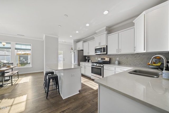 6511 Academic Ave, Raleigh, NC 27616 - kitchen with stainless steel appliances, a sink, backsplash, crown molding, and a breakfast bar area
