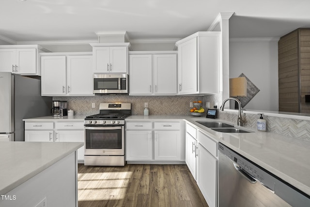 6511 Academic Ave, Raleigh, NC 27616 - kitchen with dark wood-style floors, a sink, white cabinetry, crown molding, and appliances with stainless steel finishes