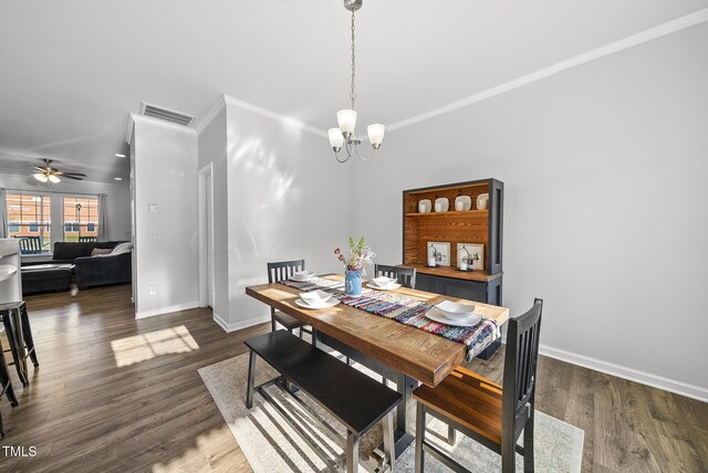 6511 Academic Ave, Raleigh, NC 27616 - dining area featuring dark wood finished floors, visible vents, baseboards, and ceiling fan with notable chandelier