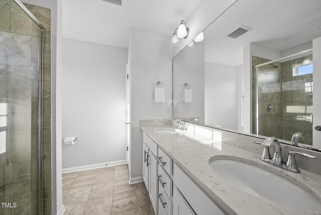6511 Academic Ave, Raleigh, NC 27616 - bathroom featuring double vanity, a shower stall, visible vents, and a sink