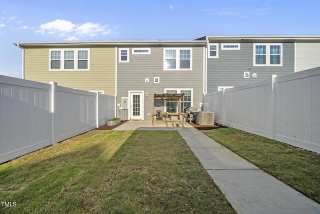 6511 Academic Ave, Raleigh, NC 27616 - back of house with a fenced backyard, central AC unit, a yard, and a patio