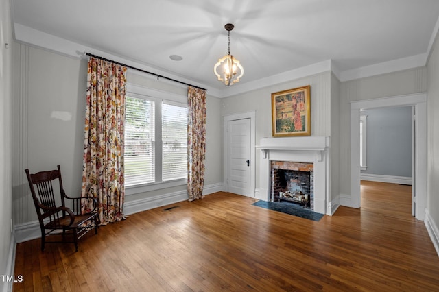 109 N Hassel St, Hillsborough, NC 27278 - unfurnished living room featuring a chandelier, a fireplace with flush hearth, and wood-type flooring