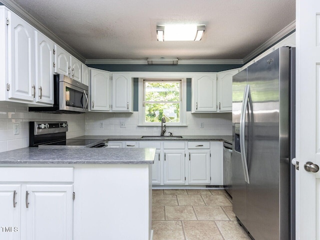kitchen featuring decorative backsplash, ornamental molding, a peninsula, a sink, and stainless steel appliances