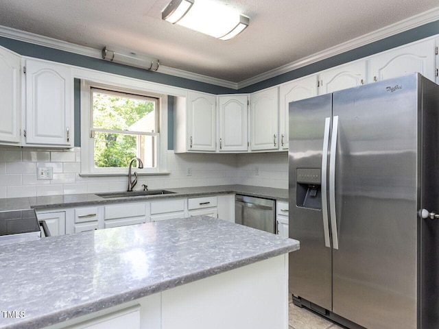 312 Heidinger Dr, Cary, NC 27511 - kitchen with white cabinets, a sink, stainless steel appliances, tasteful backsplash, and ornamental molding