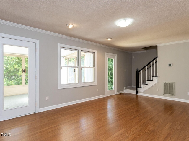 interior space featuring crown molding, a textured ceiling, wood finished floors, and stairway