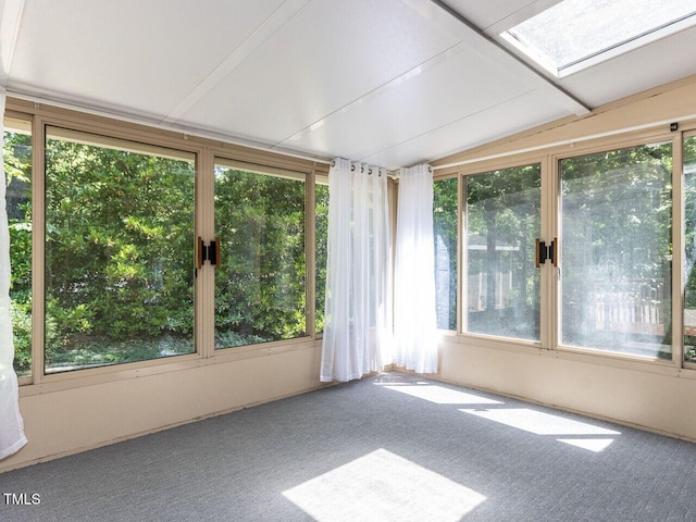 unfurnished sunroom featuring carpet floors and lofted ceiling