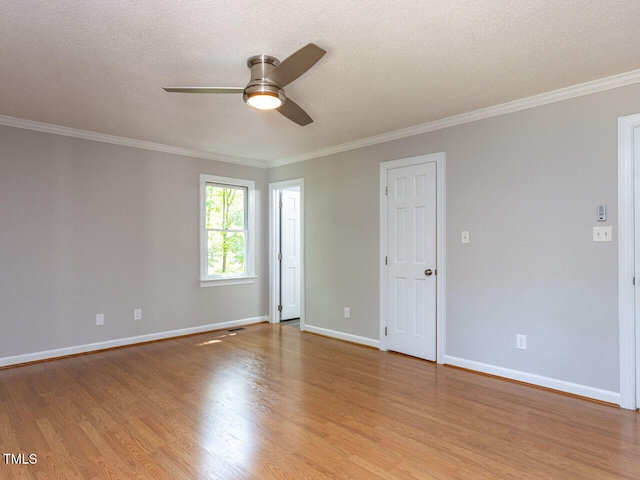 unfurnished room featuring crown molding, baseboards, ceiling fan, and light wood finished floors
