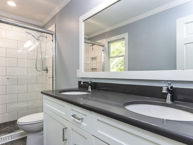 bathroom featuring double vanity, a sink, a shower stall, and ornamental molding