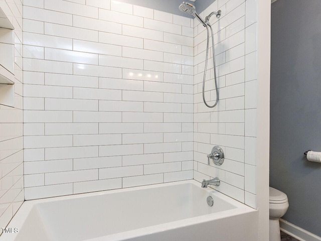 full bathroom with baseboards, bathtub / shower combination, and toilet