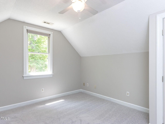 bonus room with baseboards, a ceiling fan, vaulted ceiling, and carpet flooring