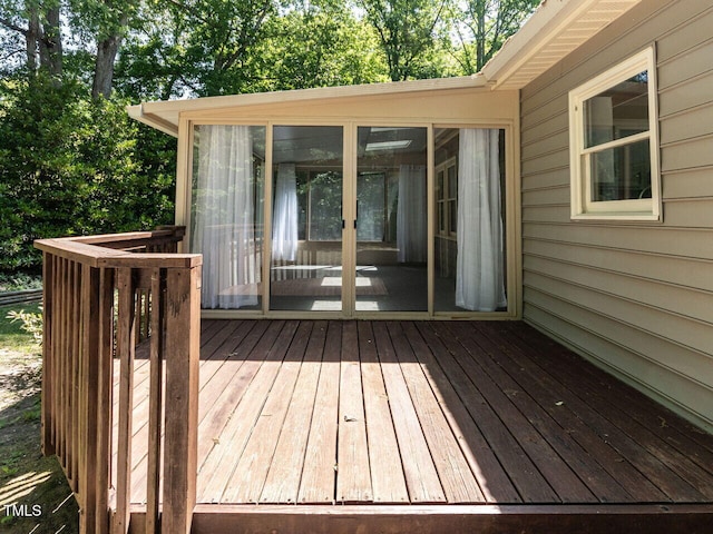 wooden deck with a sunroom