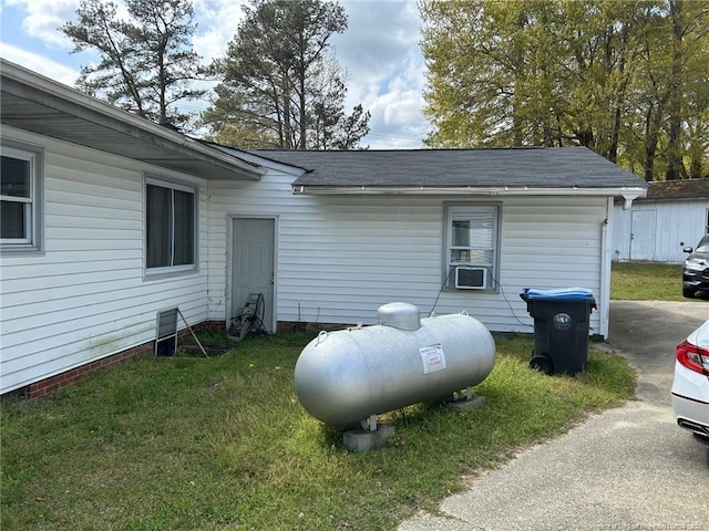 view of home's exterior featuring a yard and cooling unit