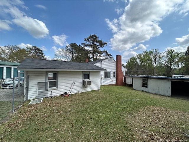 back of property with cooling unit, fence, and a lawn