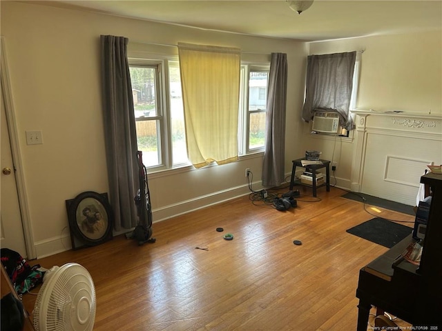 miscellaneous room featuring baseboards, light wood finished floors, and cooling unit