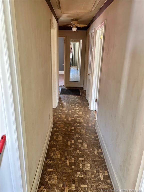 hall featuring baseboards