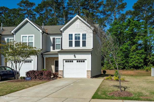 view of front facade featuring concrete driveway, board and batten siding, an attached garage, a front yard, and brick siding