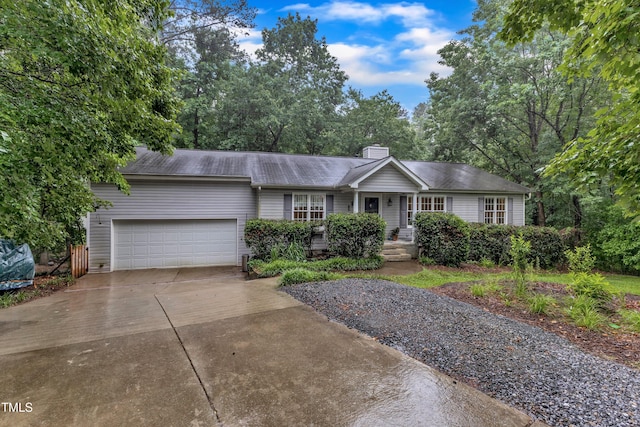1311 Theodore Ln, Durham, NC 27703 - ranch-style house with an attached garage, concrete driveway, and a chimney