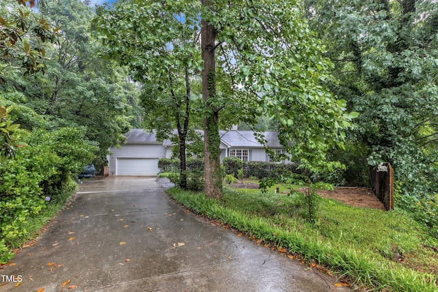 1311 Theodore Ln, Durham, NC 27703 - view of property hidden behind natural elements featuring concrete driveway