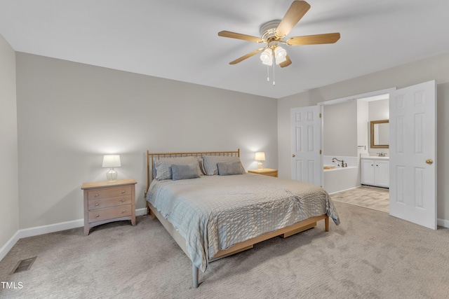 1311 Theodore Ln, Durham, NC 27703 - bedroom featuring light carpet, baseboards, and connected bathroom