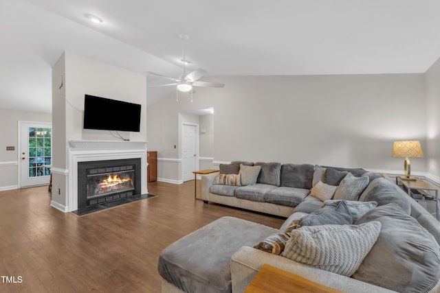1311 Theodore Ln, Durham, NC 27703 - living area featuring lofted ceiling, wood finished floors, a fireplace with flush hearth, a ceiling fan, and baseboards