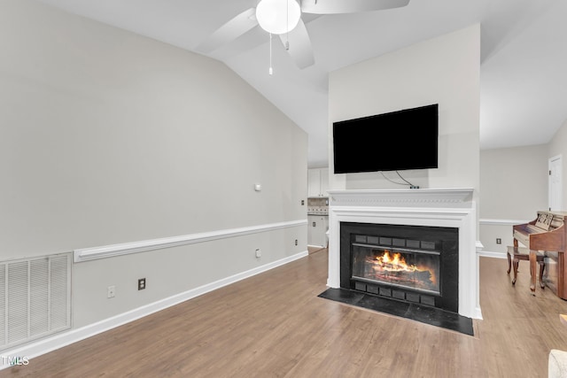 1311 Theodore Ln, Durham, NC 27703 - living room with wood finished floors, a fireplace with flush hearth, vaulted ceiling, ceiling fan, and baseboards