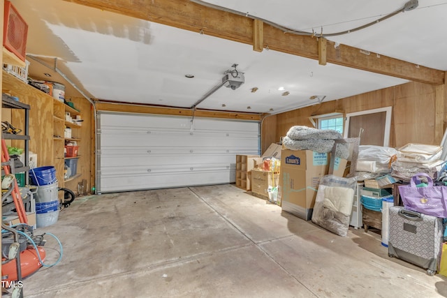 1311 Theodore Ln, Durham, NC 27703 - garage featuring a garage door opener and wood walls