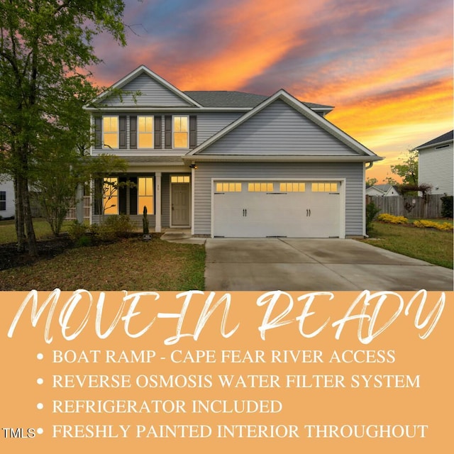 36 Slate Ln, Rocky Point, NC 28457 - view of front of property with an attached garage, driveway, and covered porch