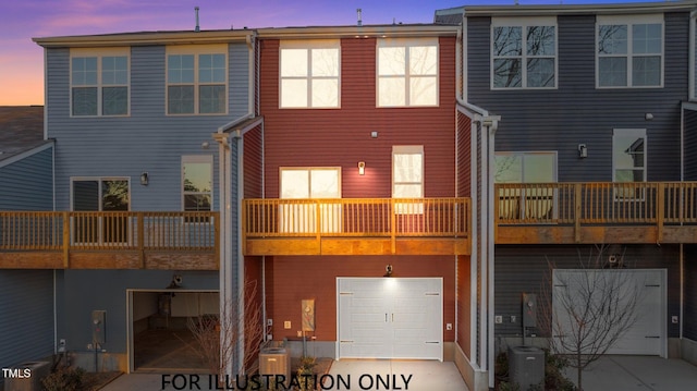 back of property featuring central AC unit and an attached garage