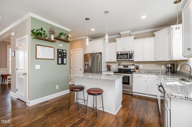 45 Leighann Ct S, Timberlake, NC 27583 - kitchen featuring appliances with stainless steel finishes, a sink, a kitchen island, recessed lighting, and white cabinets