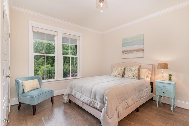 bedroom featuring crown molding, baseboards, and wood finished floors