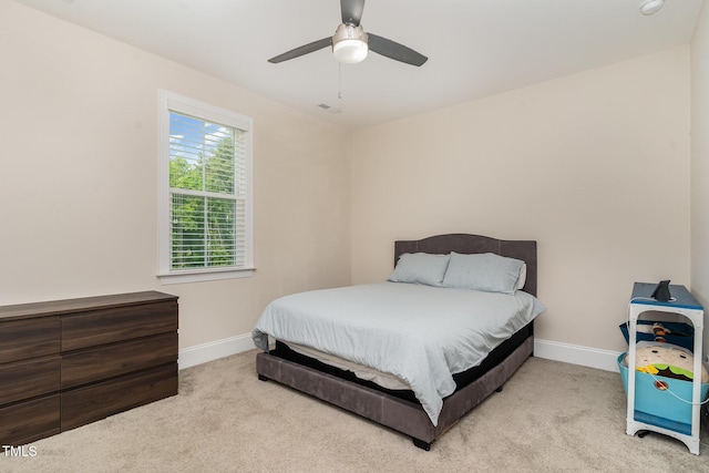 carpeted bedroom featuring a ceiling fan, baseboards, and visible vents