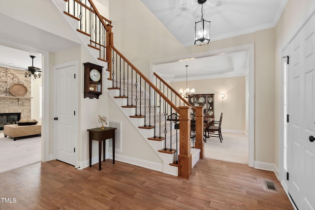 entrance foyer featuring wood finished floors, visible vents, and stairs