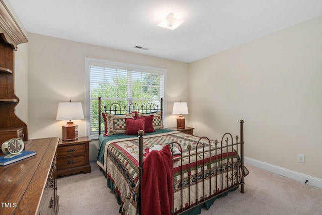 bedroom with light colored carpet, baseboards, and visible vents