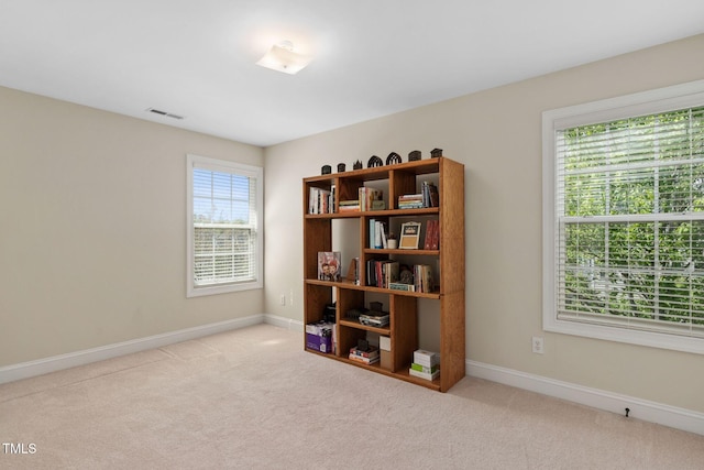 empty room with visible vents, baseboards, and carpet floors