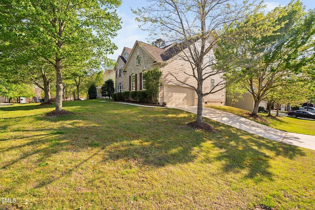 view of side of property with a yard and driveway