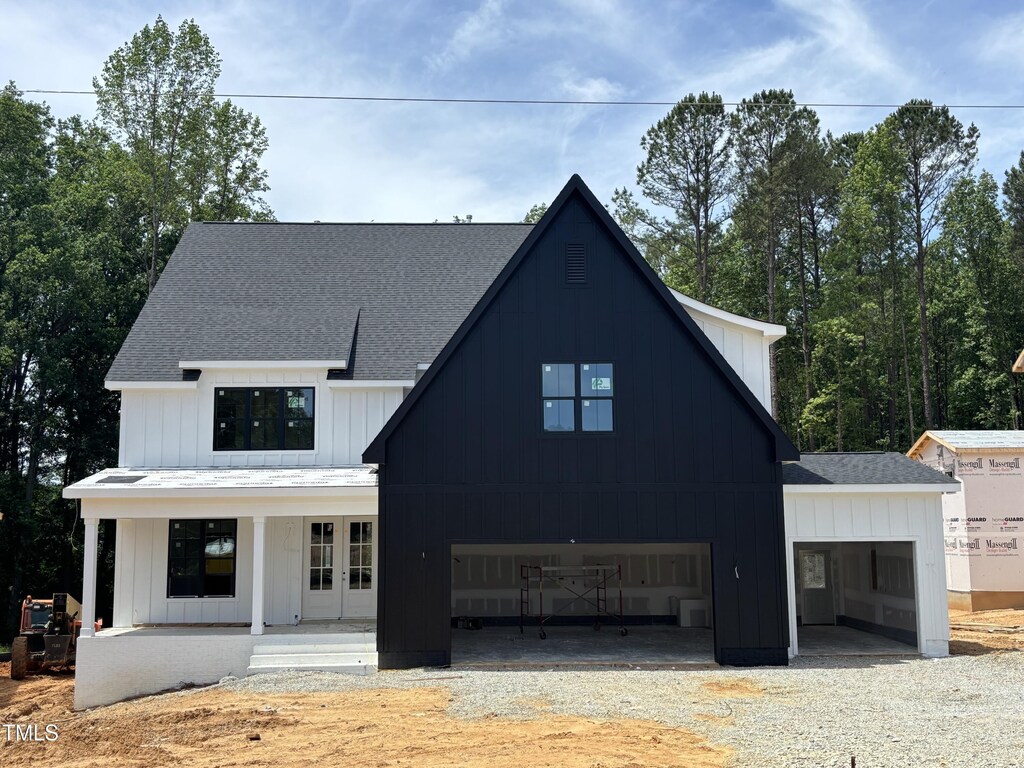2391 Herbert Akins Rd, Fuquay Varina, NC 27526 - modern inspired farmhouse featuring a shingled roof, driveway, and french doors