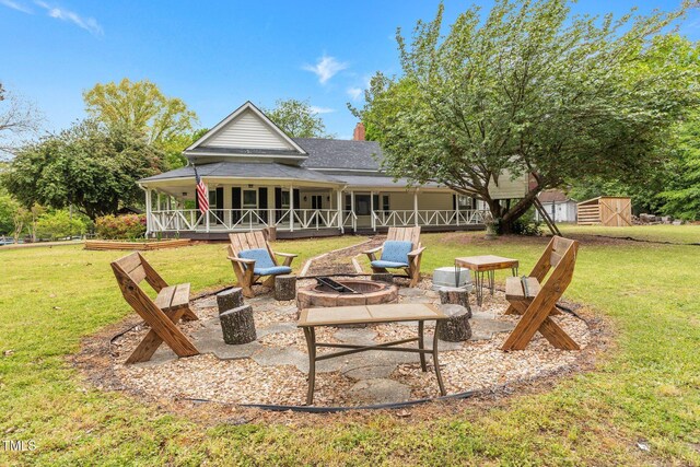 119 Johnson St, Broadway, NC 27505 - rear view of house featuring a patio, a chimney, a fire pit, an outbuilding, and a lawn