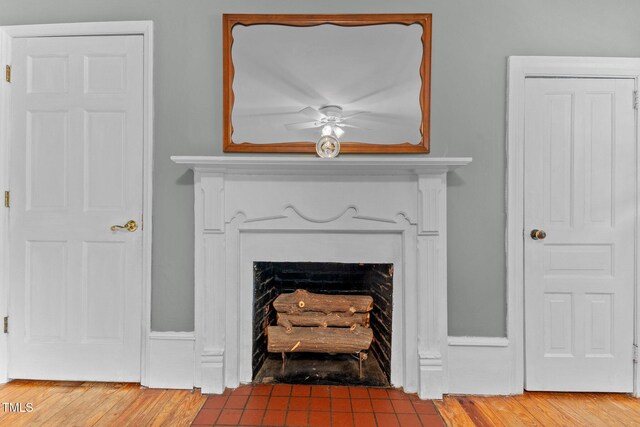 119 Johnson St, Broadway, NC 27505 - details with a fireplace with flush hearth, wood finished floors, and a ceiling fan
